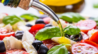 Caprese. Caprese salad. Italian salad. Mediterranean salad. Italian cuisine. Mediterranean cuisine. Tomato mozzarella basil leaves black olives and olive oil on wooden table. Recipe - Ingredients